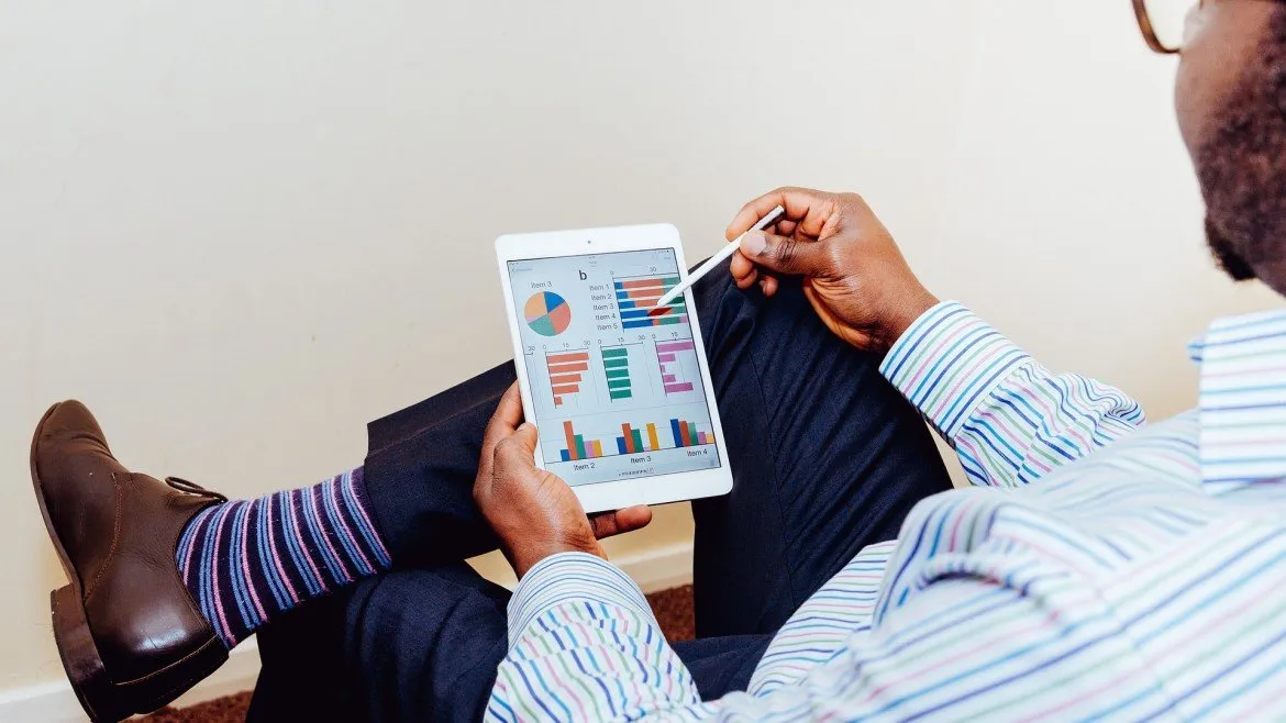 man scrolling on tablet